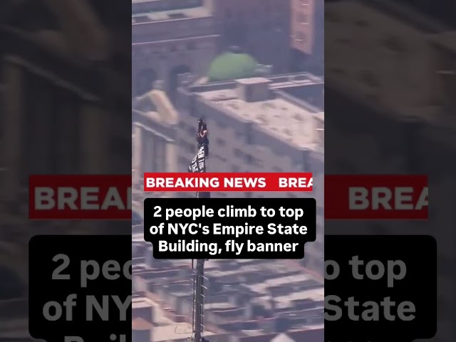 2 people climb to top of NYC's Empire State Building, fly banner